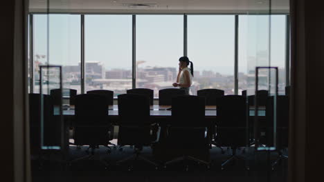 asian business woman using smartphone corporate sales executive chatting to client financial advisor negotiating deal sharing expert advice having phone call in office looking out window