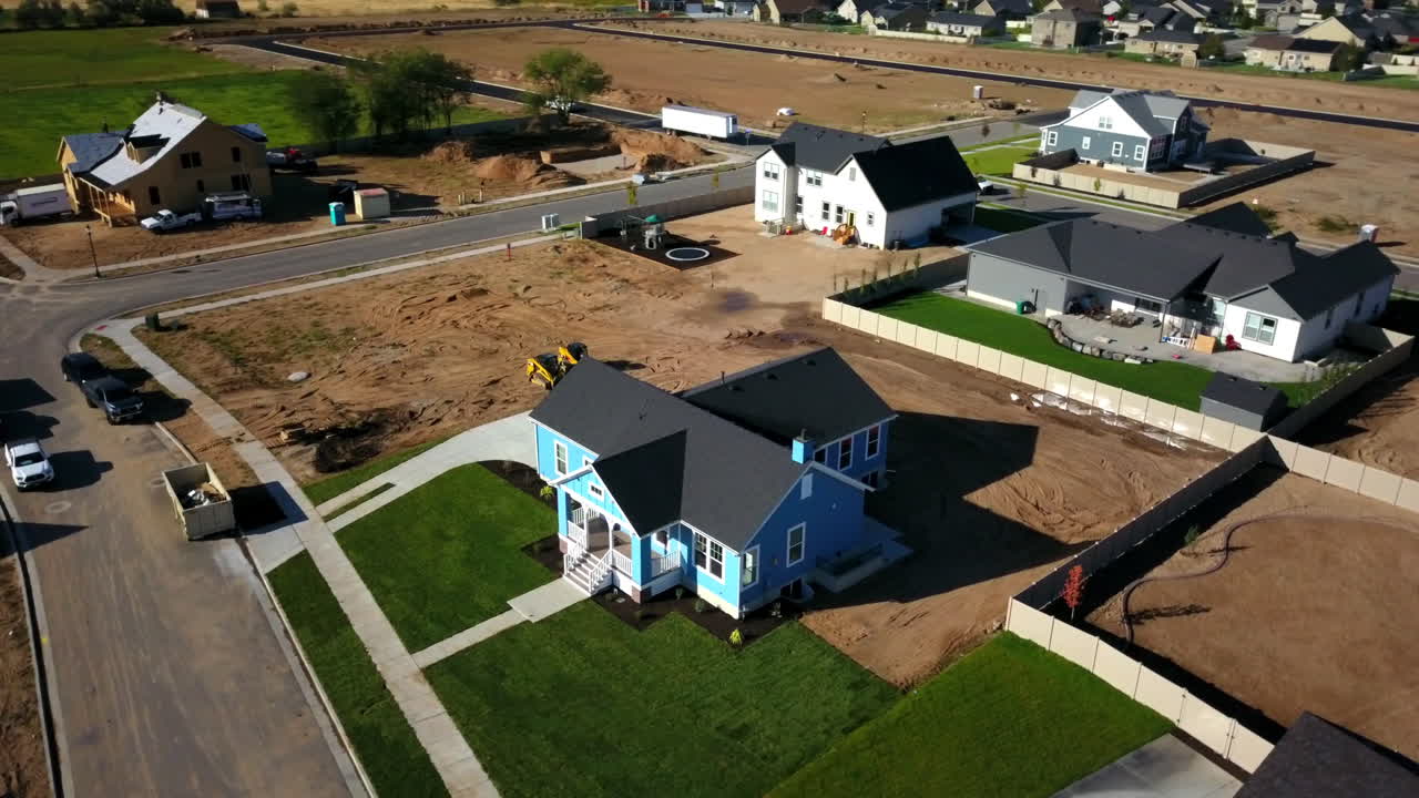 A drone shot spinning around the finishing touches on a brand new house that had just been built in the suburbs