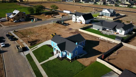 a drone shot spinning around the finishing touches on a brand new house that had just been built in the suburbs