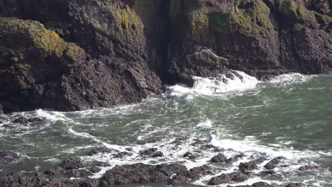 Waves-crashing-against-the-majestic-cliffs-with-vibrant-green-grass