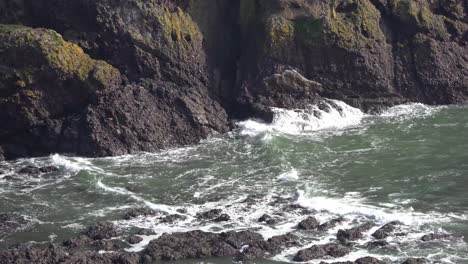 waves crashing against the majestic cliffs with vibrant green grass