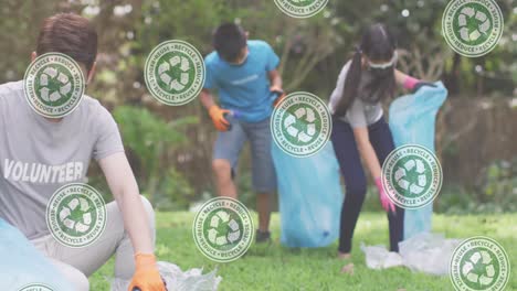 animation of green recycling signs over children with recycling sacks in park