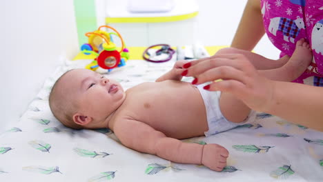 beautiful child at the reception of a doctor. curious baby watching the doctor and smiling sweetly. bright toys at the backdrop.