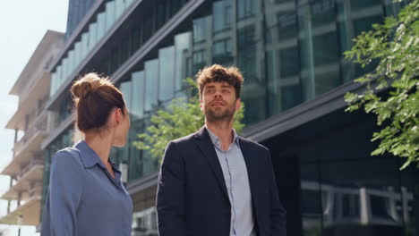 relaxed managers walking downtown street together closeup. office couple stroll