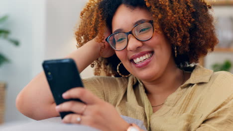 Laugh,-phone-and-black-woman-on-a-sofa-for-social