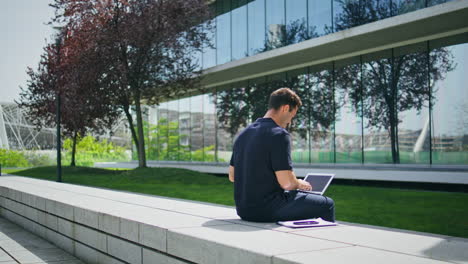 leader person working computer urban park. businessman texting laptop at bench