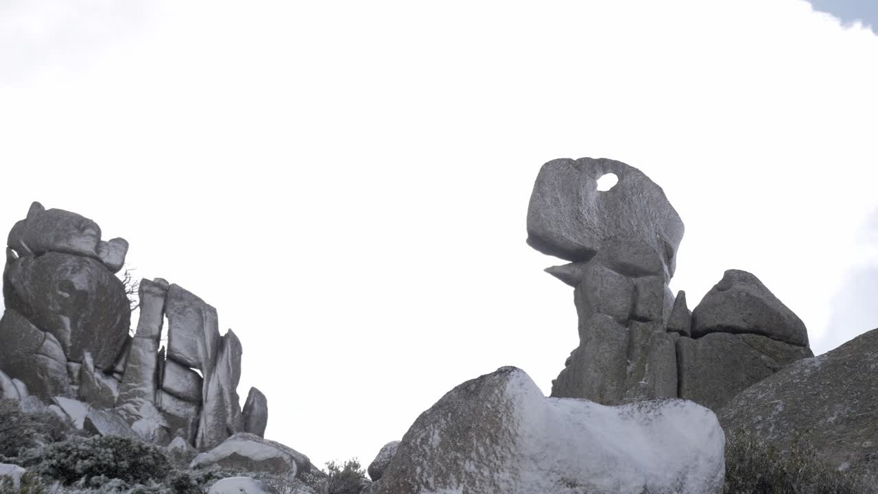 Rock formation shaped like a dinosaur in snowy Sierra de Guadarrama, Madrid