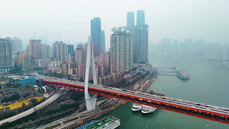 aerial view of the stunning chongqing cityscape during the day, featuring a modern bridge over the river with towering skyscrapers, showcasing the city's vibrant development and architectural design.