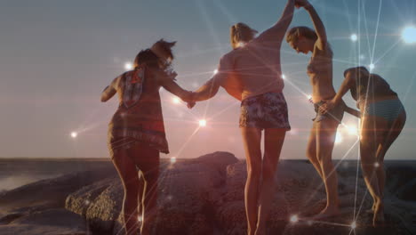 animation of networks of connections over happy group of friends having fun, walking along beach