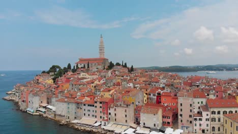 Turning-and-ascending-shot-of-a-small-town-with-colourful-houses-by-the-sea