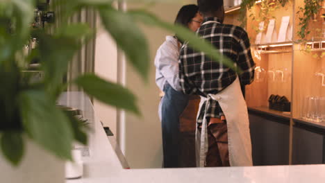 two multiethnic waiters working in a coffee shop 4