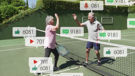 senior man and woman high-fiving on tennis court, showing social media technology icons