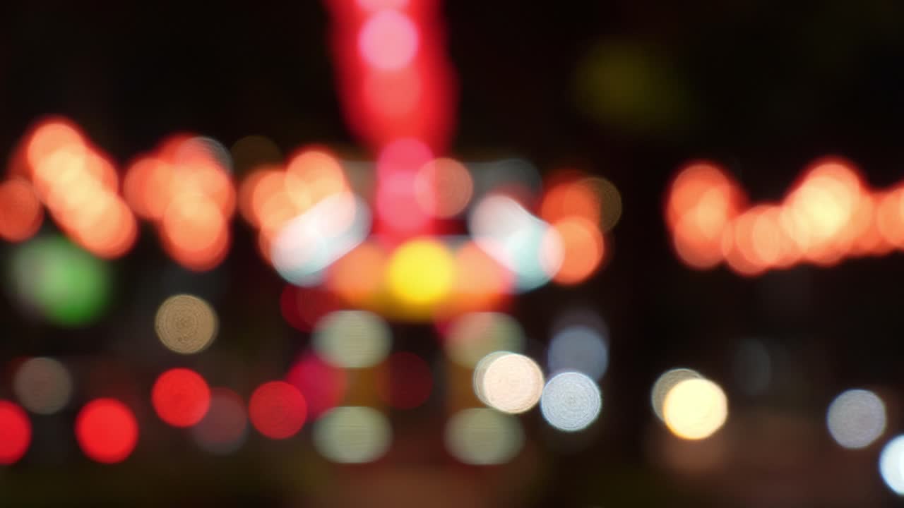 Blurry bokeh lights at night with cars and lanterns, vibrant festive street background