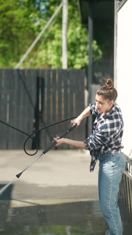 woman washing a car at a self-service car wash