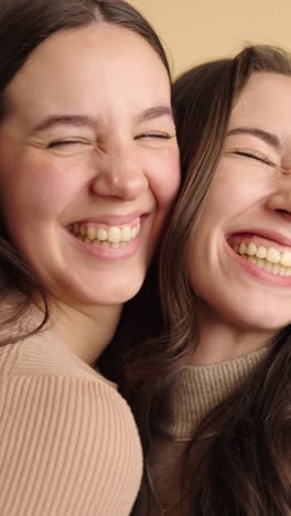 close-up of two friends laughing and hugging joyfully