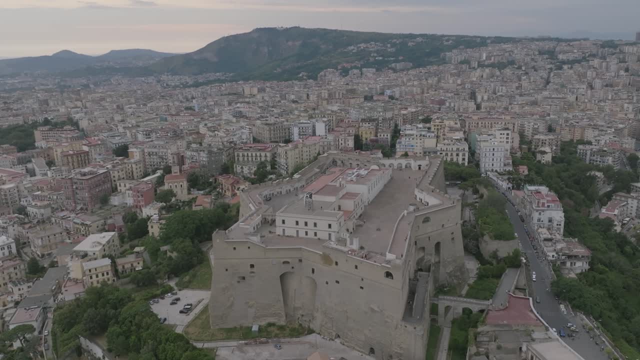 Slow aerial flyover of the Castel St'Elmo in Naples, Italy with Sunset in the background.