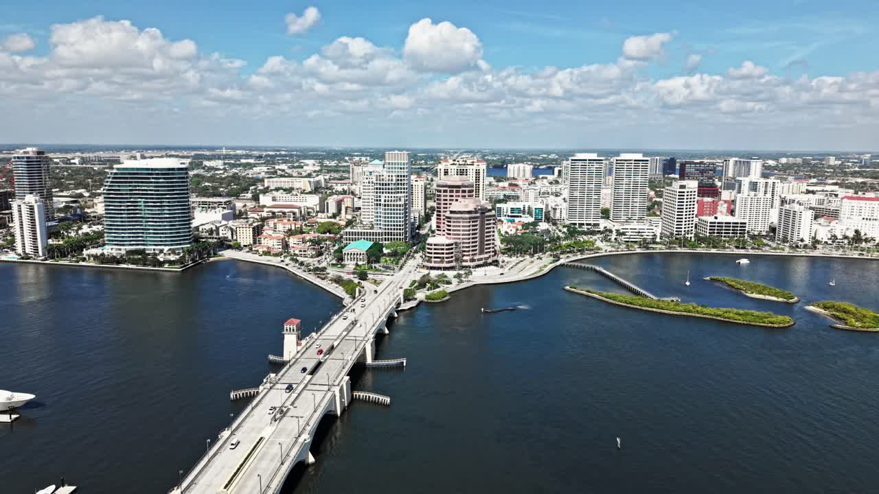Parallax drone shot of cityscape with Royal Park Bridge, One Flagler and Phillips Point building in West Palm Beach, Florida, USA