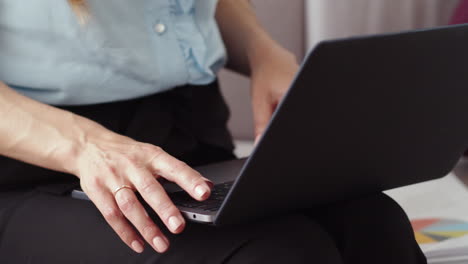 business woman starting work on laptop at home. girl typing on laptop.