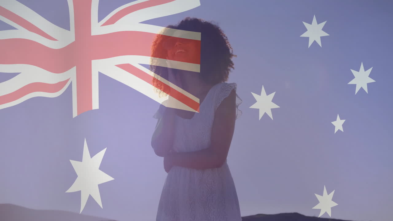 Wearing white dress, woman with Australian flag animation overlay in background
