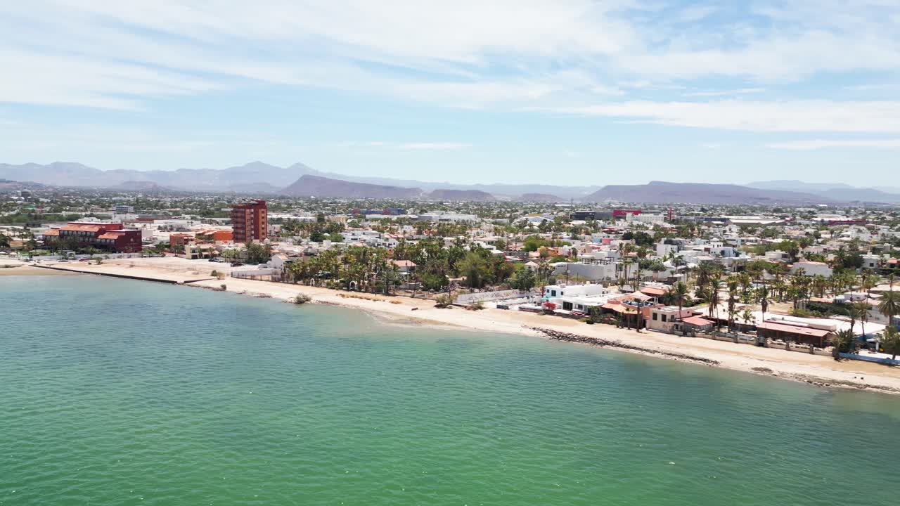 Beachfront construction site with cityscape in La Paz, Playa Posada, Mexico