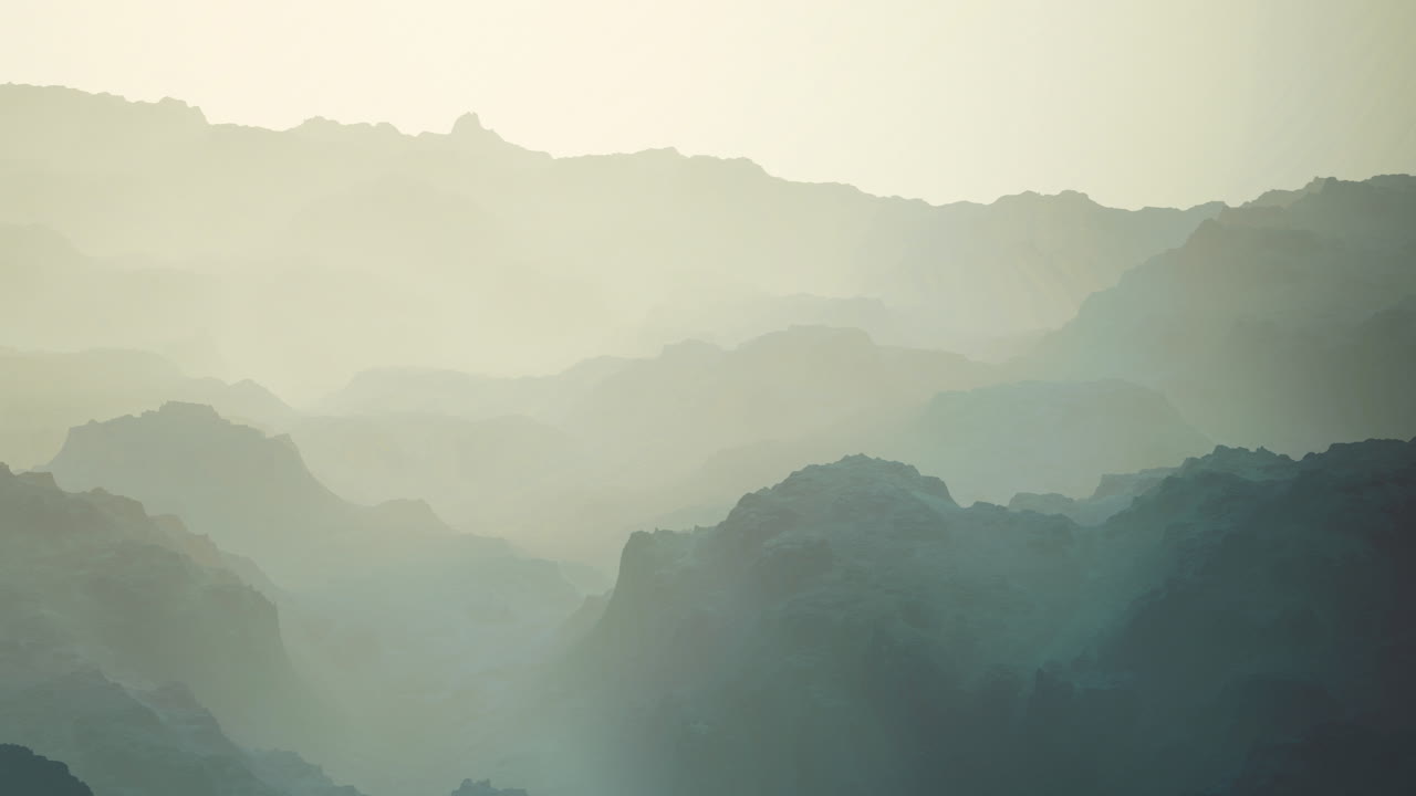 Mountain landscape shrouded in morning mist at dawn
