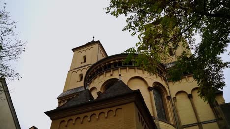 Sanstein-church-with-trees-in-Germany-in-autumn-St-Maria-im-Kamitol-with-many-beautiful-arches-and-black-windows