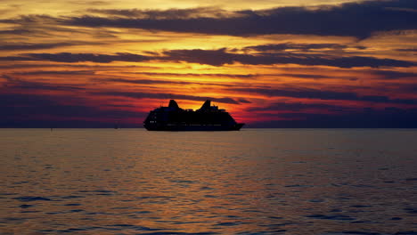cruise ship silhouette at sunset on the ocean