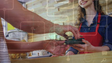 network of connections and globe over mid section of a man making a payment using his smartphone