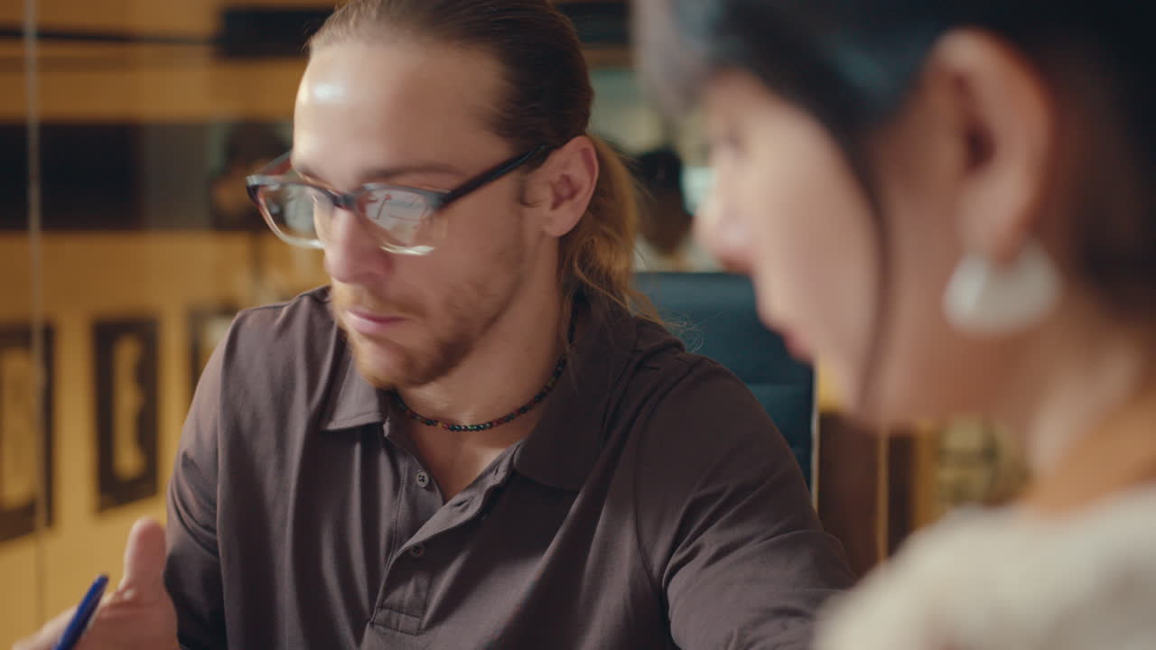 hombre de negocios explicando ideas a una compañera de trabajo en una reunión