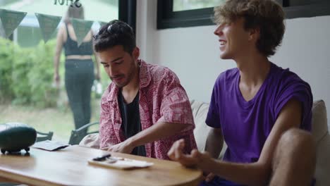 two men talking and relaxing at a cafe