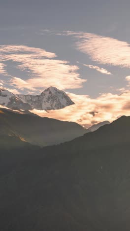 sunrise himalayas mountains timelapse in nepal, vertical video for social media instagram reels and tiktok, time lapse of annapurna mountain range at sunrise with clouds moving in beautiful light