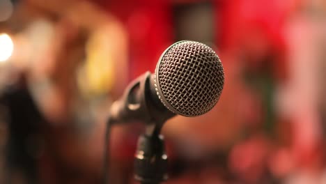 Microphone-on-stage-against-a-background-of-auditorium.