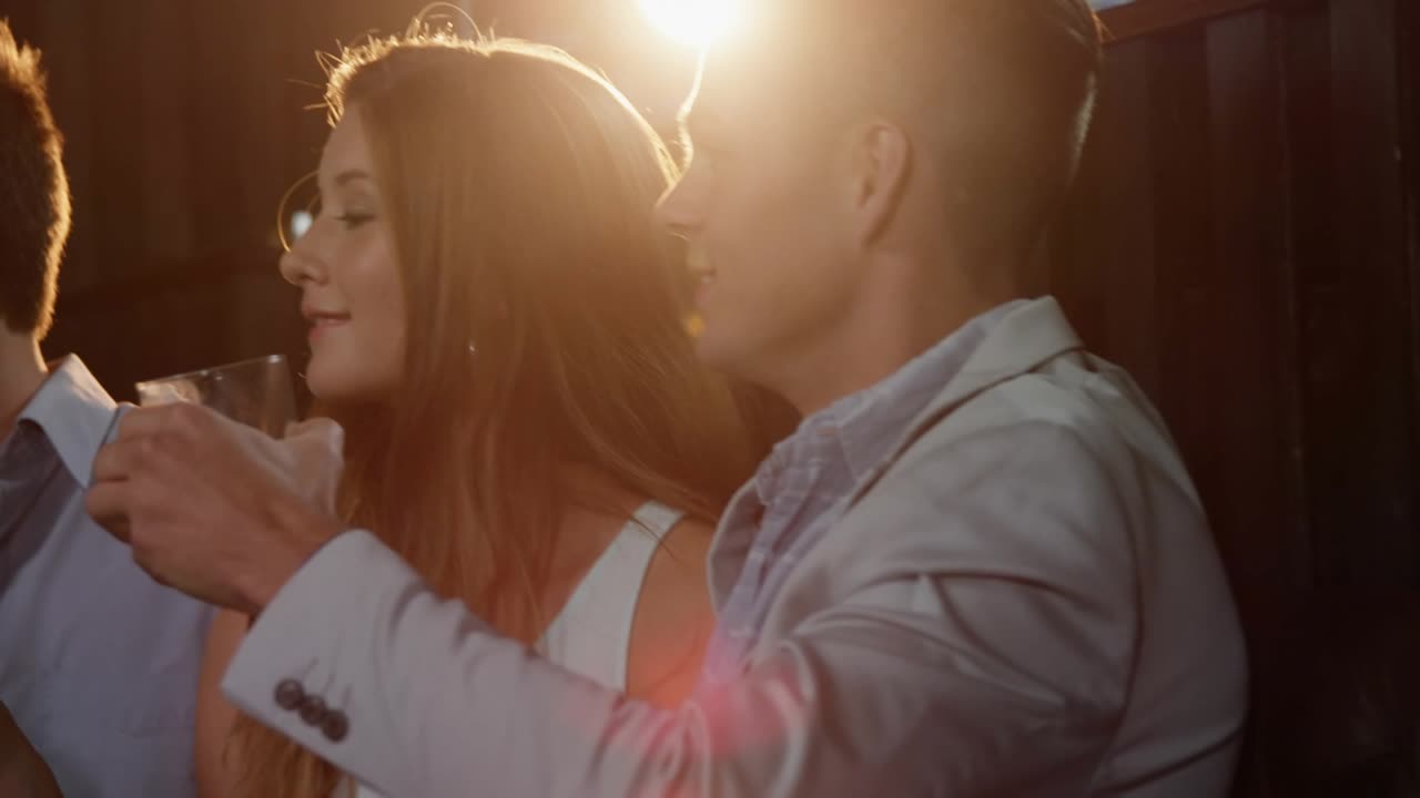 Man reaching forward starting group toasting drinks at event, purple graphics drifting across faces