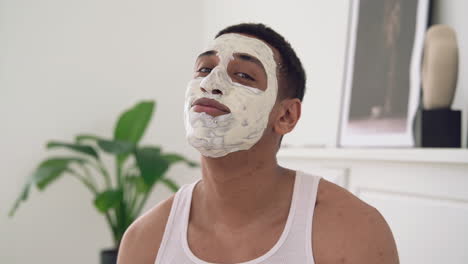 portrait of a handsome black man with facial mask looking at camera and smiling 1