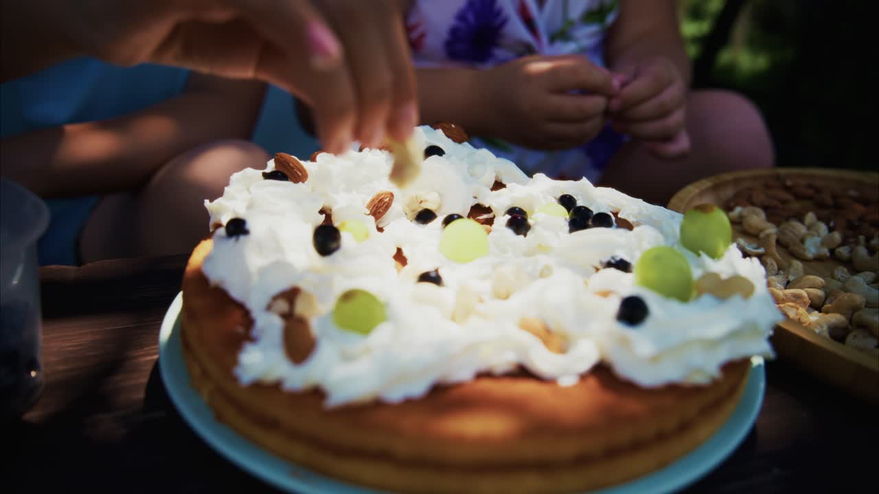 Delicious dessert topped with whipped cream, nuts, and fresh fruit on a rustic wooden table
