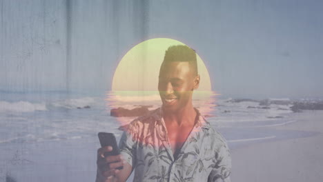 smiling man using smartphone on beach with sunset animation overlay