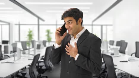 happy indian manager talking to someone on call