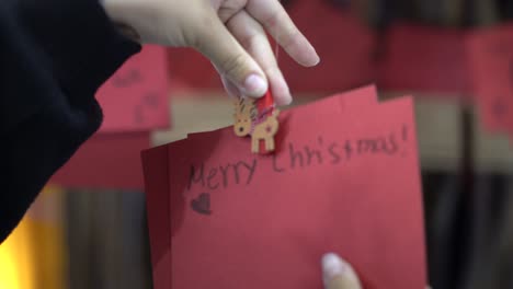 a child hangs her christmas wish