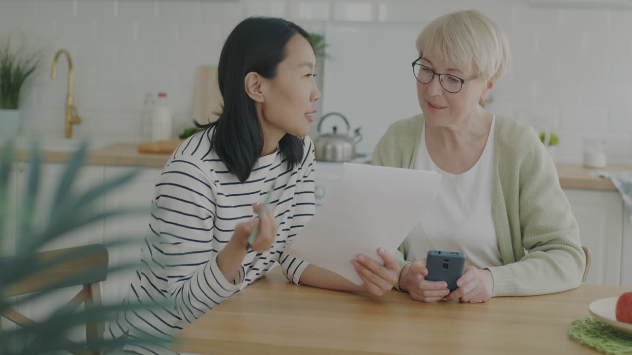 Mother and daughter discussing documents