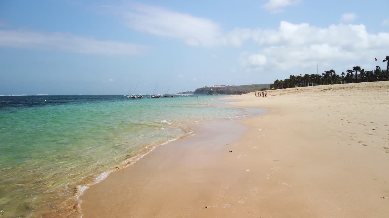 Amazing Bali Indonesia Nusa Penida beach with turquoise blue ocean and white sand panoramic view and adventure destination. Waling around with hand held camera.