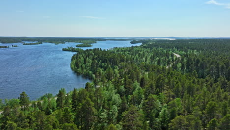 aerial: motorhome driving on a distant road at lake inari, summer day in finland