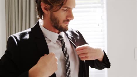 man getting dressed in bedroom