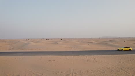yellow convertible car in the desert