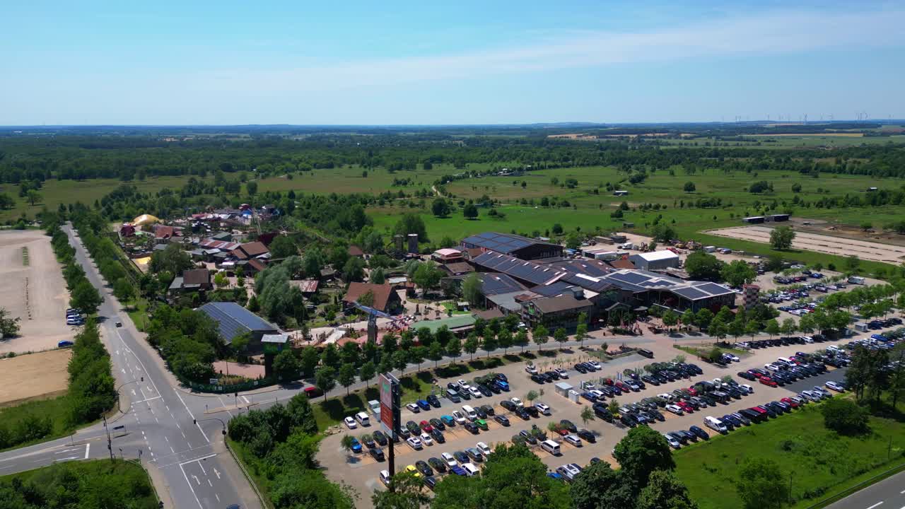 Amusement park with roller coasters, various attractions, and green spaces in Germany. speed ramp hyper motion time lapse. Best aerial view flight fly push forward drone