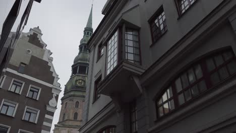 desolate scenery inside narrow european street with church tower