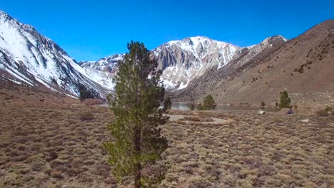 An-rising-aerial-over-the-Sierra-Nevada-mountains-reveals-an-attractive-lake