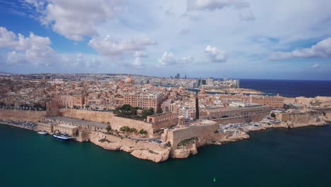 stunning aerial landscape of valletta in malta with dramatic clouds on sunny day