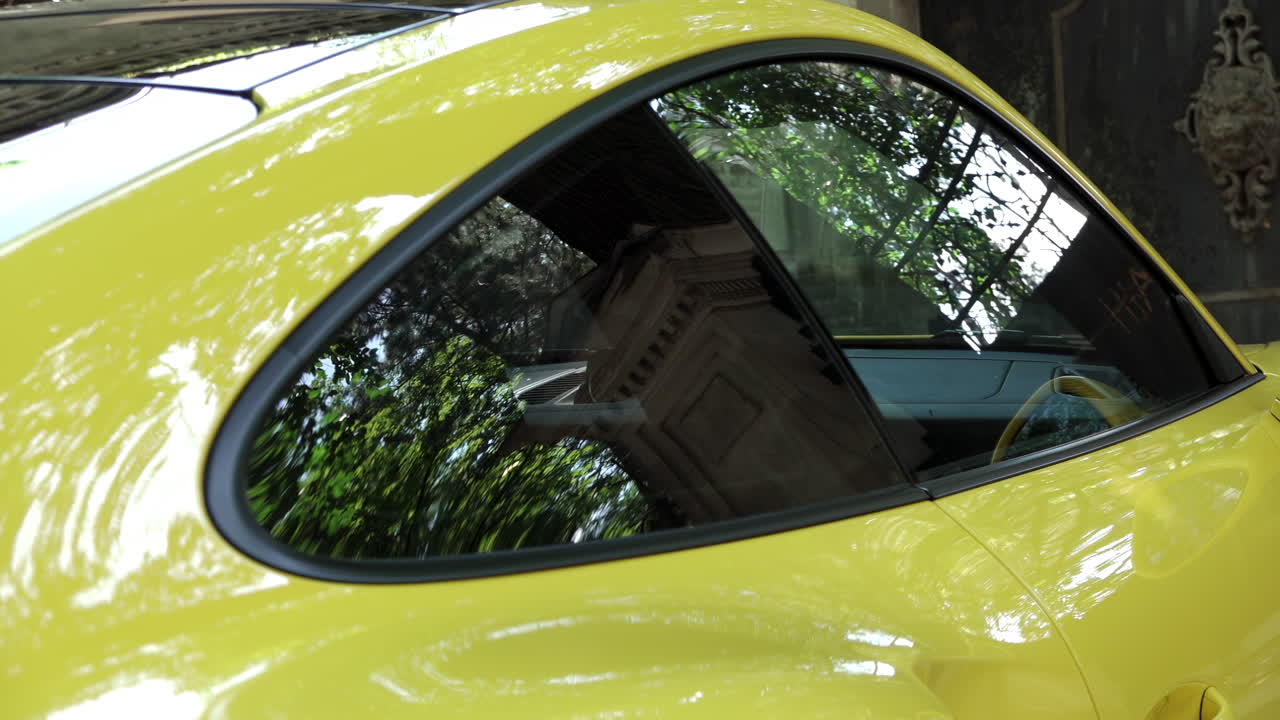 Close up of the side of a yellow car in daylight