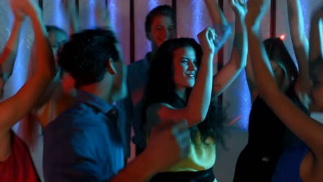 Group-of-smiling-friends-dancing-on-dance-floor