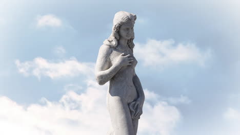 animation of gray sculpture of woman over blue sky and clouds